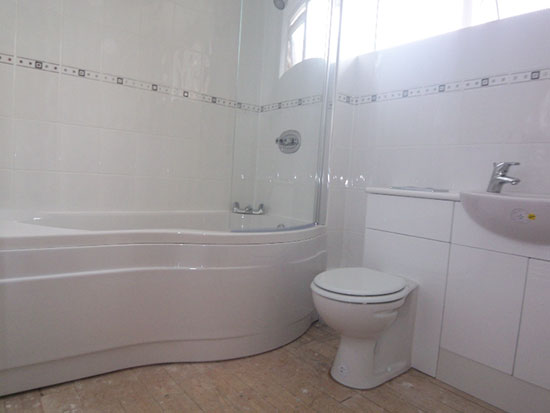 White bathroom with curved bath